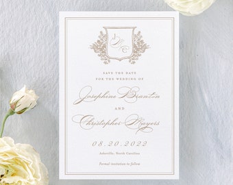 May include: Save the date card with a floral design and a crest featuring the initials "J & C". The card announces the wedding of Josephine Branton and Christopher Mayers on 20 August 2022 in Asheville, North Carolina.