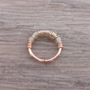 Cartilage hoop made with 14K rose gold filled wire and pale green glass beads in the UK