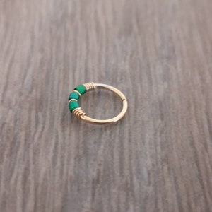 Daith hoop earring made with gold filled wire and green glass beads