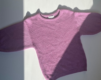 May include: A soft, lilac-colored knitted sweater with long sleeves and a crew neckline.