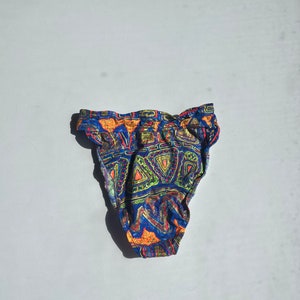 May include: Blue, orange, green, and yellow patterned bikini bottom with a high waist.