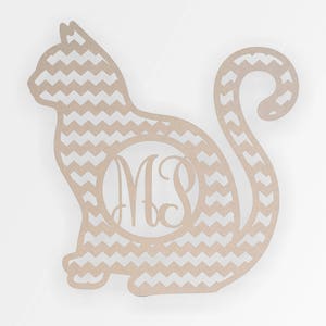 May include: A wooden cutout of a cat with a chevron pattern. The cat has a circle in the middle with the monogram "MS" inside.