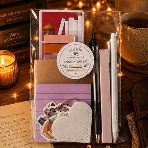 May include: A clear plastic bag containing an annotation kit with a round label reading Acorn House Trading Company Annotation Kit, highlight, note, remember. Includes a stack of purple lined sticky notes, a white heart-shaped clip, pens, and markers.