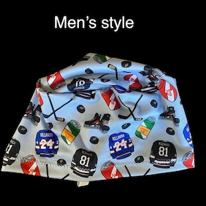 May include: A light blue fabric head covering featuring a repeating pattern of hockey jerseys with the text "HOLLANDER 24" and "ROZANOV 81," hockey sticks, pucks, and soda cans. The text "Men's style" is printed in white above the fabric item.
