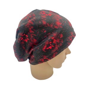 May include: A black and red floral print beanie hat.