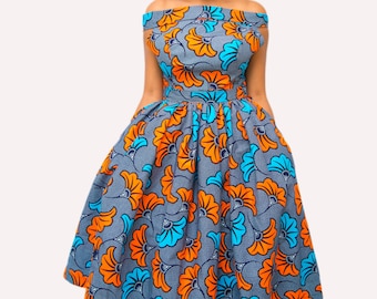 May include: A woman wearing a blue, orange, and turquoise floral print off-the-shoulder dress with a fitted bodice and a full skirt.