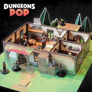May include: A tabletop role-playing game set featuring a multi-room building with miniature figurines. The building has a detailed interior with a fireplace, tables, and decorative elements. The scene is set on a green map with the text "DUNGEONS POP" at the top.