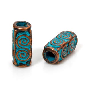 May include: Two turquoise blue and copper coloured cylindrical beads with a spiral design.