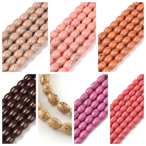May include: A collection of oval-shaped beads in various colors, including beige, peach, orange, brown, tan, pink, and coral. Each bead has a speckled, marbled appearance with black veining. These beads are strung together, showcasing their potential for jewelry making.
