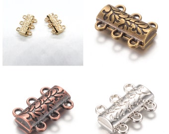 May include: Four magnetic clasps in gold, antique brass, copper, and silver tones. Each clasp features a decorative floral design and four loops for attaching jewelry.