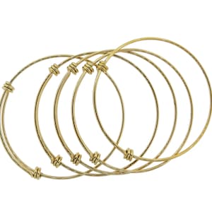 May include: Set of four gold-toned bangle bracelets with knotted accents.