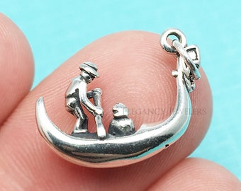 May include: Silver charm of a gondolier rowing a gondola. The charm is detailed and has a loop for attaching to a bracelet or necklace.