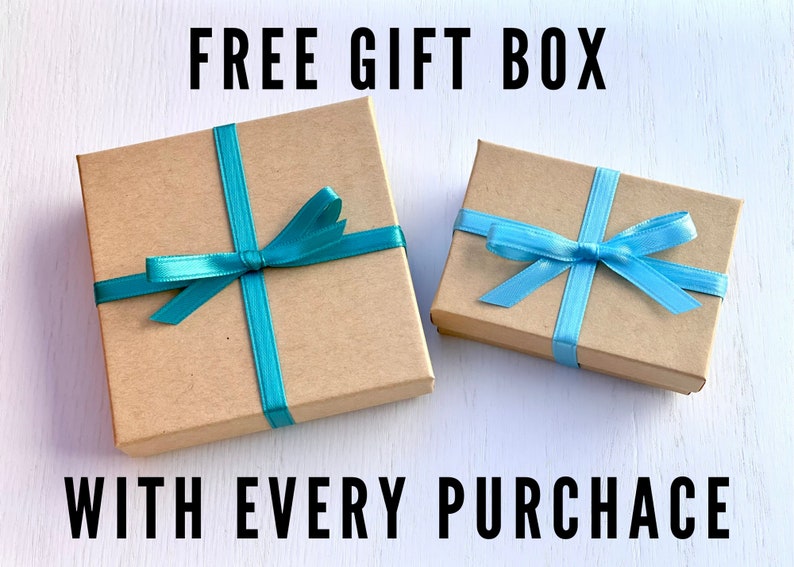 A free gift box is included with the purchase of a pair of earrings. The image shows two nice jewelry boxes tied with blue ribbons.