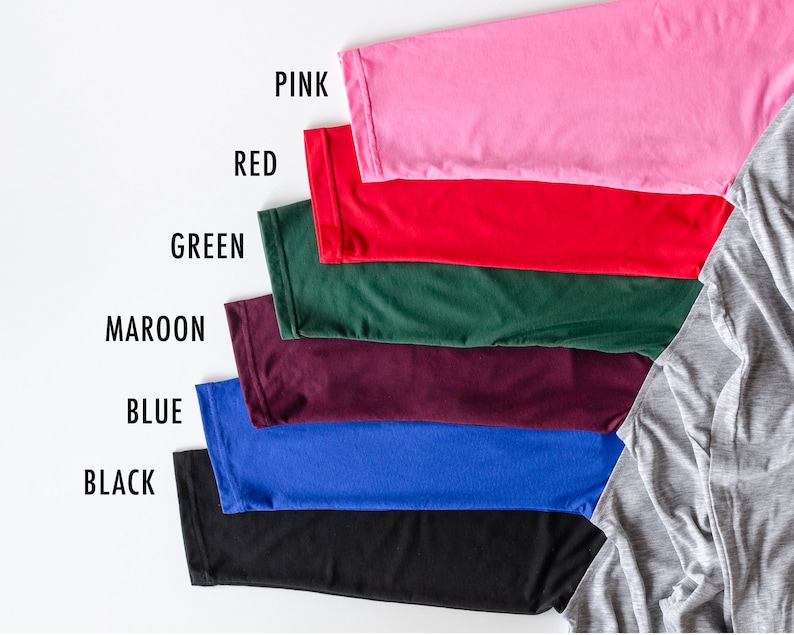 May include: A set of seven fabric swatches in various colors, including pink, red, green, maroon, blue, black, and gray. The swatches are arranged in a row from top to bottom, with the gray swatch at the bottom right.