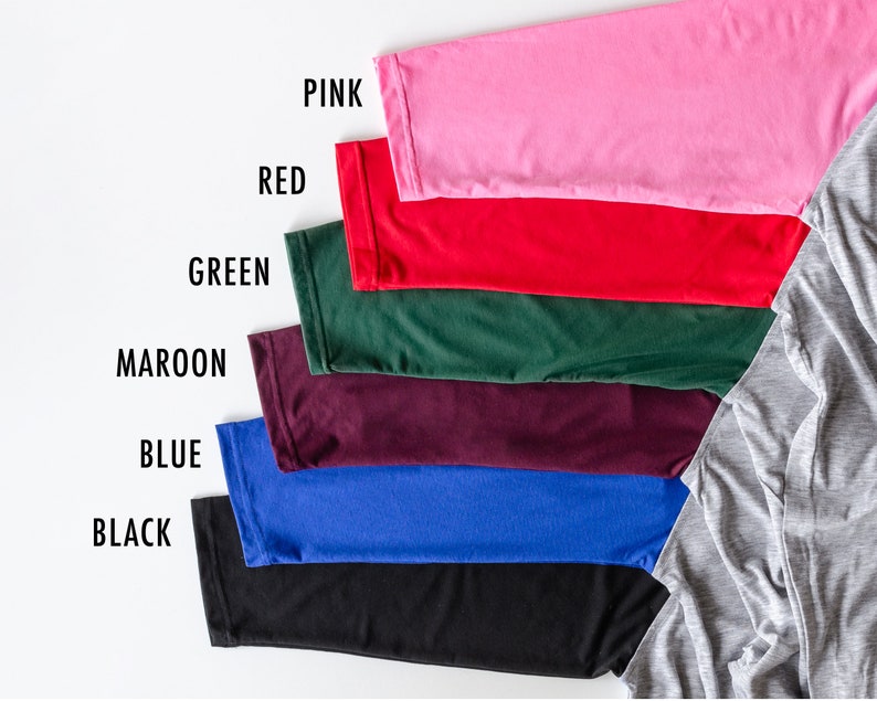 May include: A set of seven fabric swatches in various colors, including pink, red, green, maroon, blue, black, and gray. The swatches are arranged in a row from top to bottom, with the gray swatch at the bottom right.