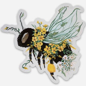 May include: A black and yellow bee with wings made of green leaves and yellow flowers. The bee is surrounded by yellow and white flowers. The artist's signature, "Ashley Darling", is in the bottom right corner.
