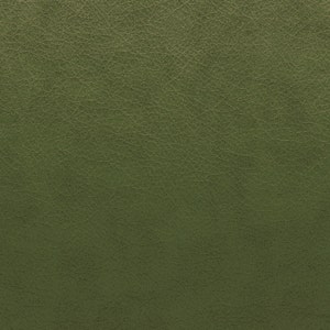 May include: Close-up of olive green leather with a textured surface. The leather has a slightly distressed appearance, with fine lines and subtle variations in color. This material is suitable for upholstery, accessories, or other craft projects.