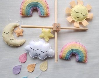 Pastel rainbow mobile. Cot or ceiling mobile. Rainbow, clouds, moon and stars on a wooden cross frame in pastel shades