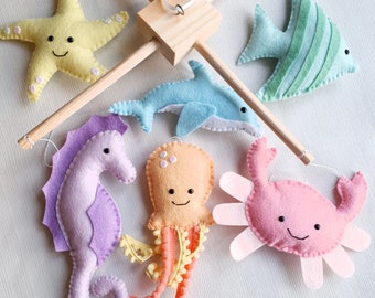 Rainbow under the sea theme mobile on a wooden frame