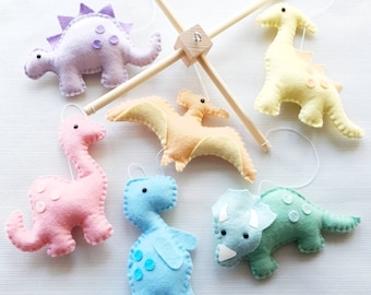 Pastel rainbow dinosaur mobile on a wooden frame