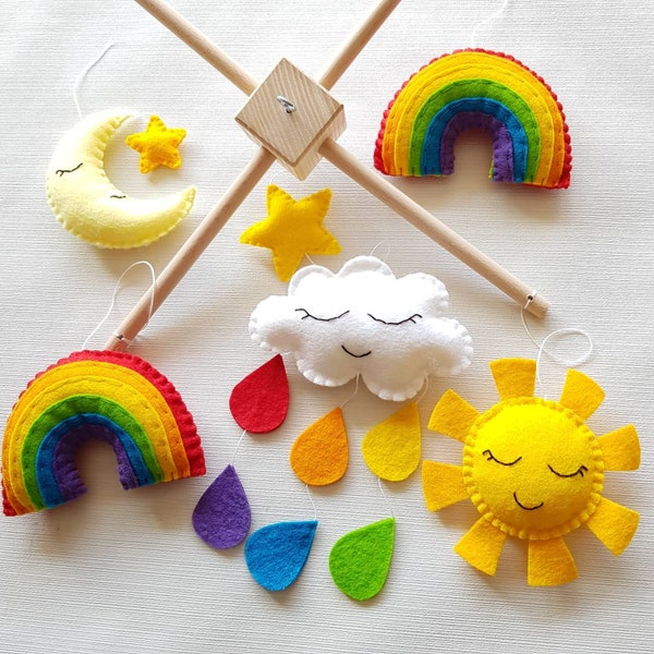 Rainbow mobile. Cot or ceiling mobile. Rainbow, clouds, moon and stars on a wooden cross frame.