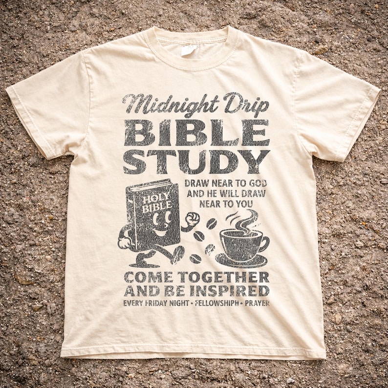 May include: Cream-colored t-shirt with a distressed black graphic. The graphic reads "Midnight Drip BIBLE STUDY" with illustrations of a smiling Bible, coffee cup, and coffee beans. Text includes "Draw near to God" and "Come together and be inspired."