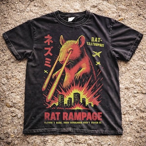 May include: Black t-shirt with a graphic of a rat emitting laser beams, above a city skyline. The text reads "RAT RAMPAGE" and "NATURE'S RAGE. YOUR INSURANCE WON'T COVER IT."