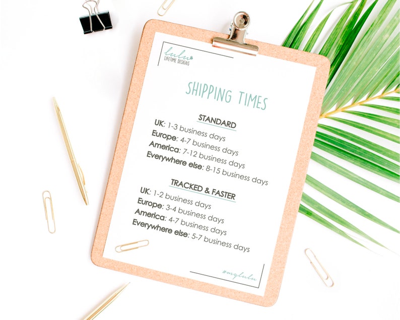 May include: A close-up of a corkboard with a white sheet of paper attached to it. The paper has the text "SHIPPING TIMES" in a teal blue font. The paper lists estimated shipping times for different locations, including the United Kingdom, Europe, America, and everywhere else. The shipping times are categorized as "STANDARD" and "TRACKED & FASTER".