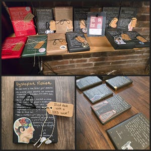 May include: A display of wrapped books, some with handwritten notes and decorative tags. The books are in various colors, including red, green, and brown. One sign reads "Blind date with a USED book!"