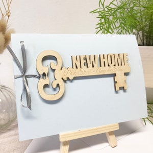 wooden key shape engraved with your special message and names of the new home owners attached to a card as a housewarming keepsake gift