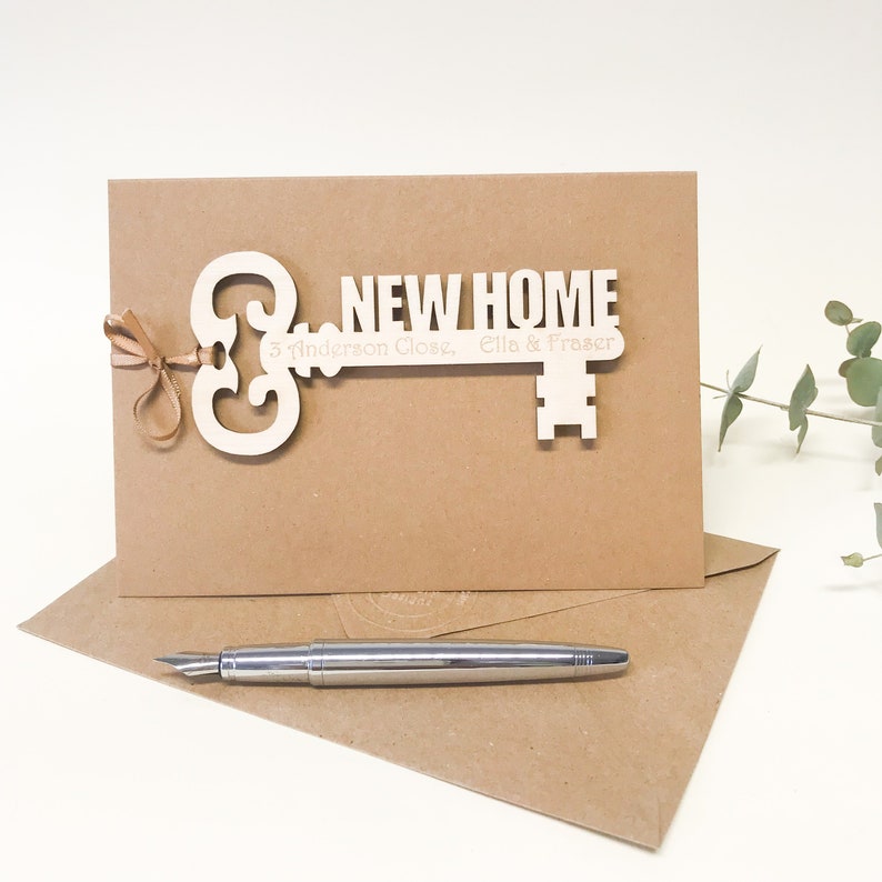 wooden key shape engraved with your special message and names of the new home owners attached to a card as a housewarming keepsake gift