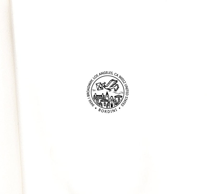 May include: A circular black and white stamp with the text "Broadway Los Angeles, CA 90012, United States" and the name "Bordini". The stamp features a flying bird carrying a letter and a depiction of buildings.
