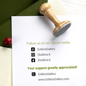 May include: A wooden stamp with a gray imprint surface rests on a white paper. The text "Follow us on our social media:" and social media icons are visible. The text "Your support greatly appreciated!" is also present.