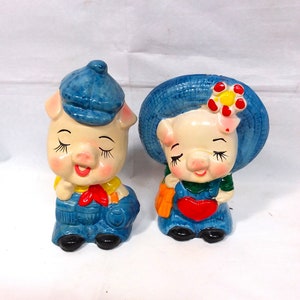Money box, childrens piggy banks. 2 times money boxes a boy and girl in red and blue.