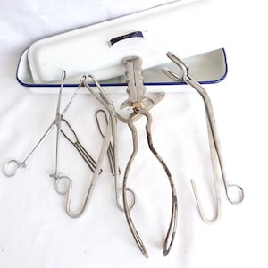 Old Medical items, large instruments, vintage surgical tools, and old tin sterilizer.  Vintage surgeons tools mid century instruments.