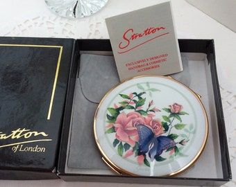 Stratton mirror compact, floral design with blue butterfly gold tone 1960s ladies handbag accessory.