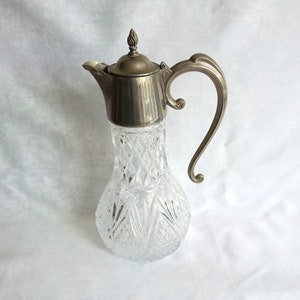 Claret jug, silver plate cut glass decanter, lovely patterned detail to lid and handle.