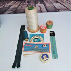 Wooden bobbins and other sewing accessories, 1950s hooks and eyes, zips, tape measure, press studs, vintage crafting.