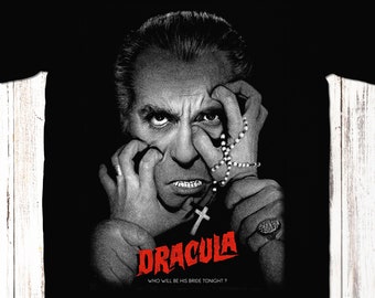 May include: Black t-shirt with a graphic of Dracula from the classic horror film. The image shows Dracula's face with a cross necklace and the text "Dracula, Who will be his bride tonight?"
