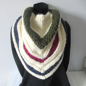 May include: A white knitted cowl with stripes of navy blue, burgundy, and olive green. The cowl is folded over and has a textured design.