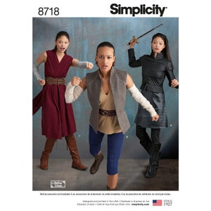 May include: A Simplicity sewing pattern for three different costumes. The pattern is number 8718. The costumes are a red dress with a brown belt, a gray vest with a brown belt and blue pants, and a black jacket with a black skirt.