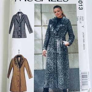 May include: A sewing pattern for a long coat with a faux fur collar. The pattern is from McCall's and is size Y (XSM-SML-MED). The pattern includes three different views: a plaid coat, a brown coat, and a leopard print coat.