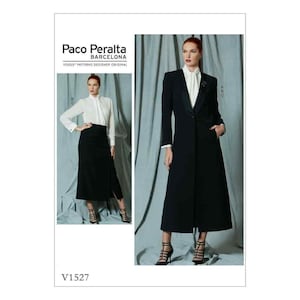 May include: A black long-sleeved coat with a shawl collar and a single button closure. The coat has a long, flowing silhouette and is worn by a model with a white blouse and black skirt. The image includes the text "Paco Peralta Barcelona Vogue Patterns Designer Original V1527".
