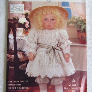 May include: Vogue Craft doll pattern featuring a doll with a straw hat, curly blonde hair, and a white lace dress. The pattern includes a full-color iron-on transfer for the face. The doll is part of the Vogue Doll Collection.