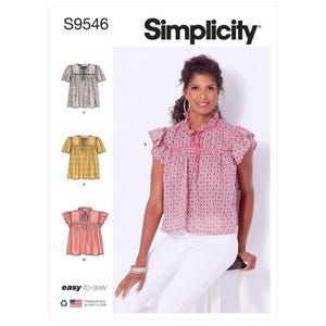 May include: Simplicity sewing pattern S9546. The pattern features three blouse designs, including a pink paisley print blouse with a ruffled collar and sleeves. The model is wearing the pink blouse with white pants. The pattern is easy-to-sew and designed and printed in the USA.