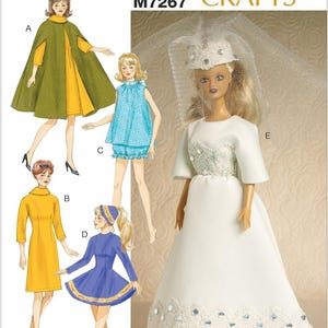 May include: A McCall's Crafts pattern featuring illustrations of doll clothing designs. The designs include a cape and dress, a blue top and shorts set, a yellow dress, a blue dress, and a doll in a white wedding dress.