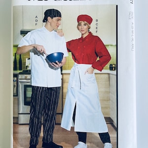 May include: A sewing pattern for a chef's uniform, featuring a white chef's jacket with black and white striped pants and a red chef's jacket with a white apron. The pattern is from McCall's and is for sizes S-M-L-XL-XXL.