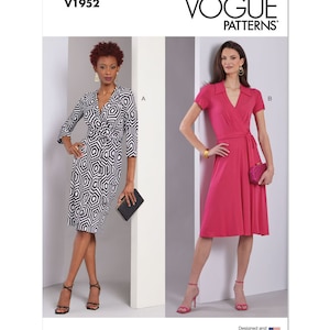 May include: Vogue Patterns sewing pattern for a wrap dress with a collar. The pattern includes two variations: a black and white geometric print dress and a solid pink dress. The pattern is labeled V1952.