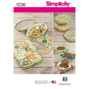 May include: Simplicity sewing pattern number 1236 for making a set of fabric food covers. The pattern includes instructions for making covers for a casserole dish, a pie, and a loaf of bread. The covers are made from a green fabric with a floral pattern.