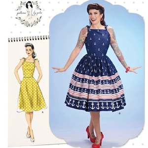 May include: Simplicity sewing pattern S8873. The image shows a woman wearing a navy blue dress with white anchor and red stripe details. The dress has a square neckline and a full skirt. The pattern includes a sketch of a yellow polka dot dress.